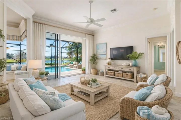 Living room Staged, ornamental molding, and ceiling fan