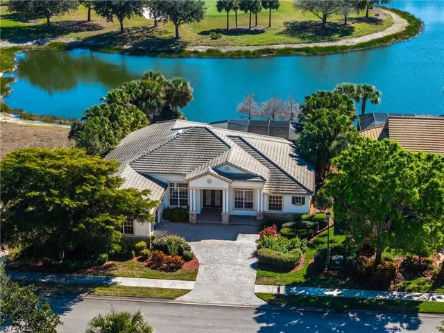 Aerial view of property and surrounding area with a nearby body of water