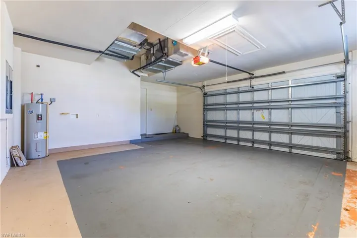 Garage with electric water heater and a garage door opener