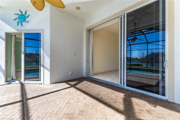 View of patio with ceiling fan and a water view