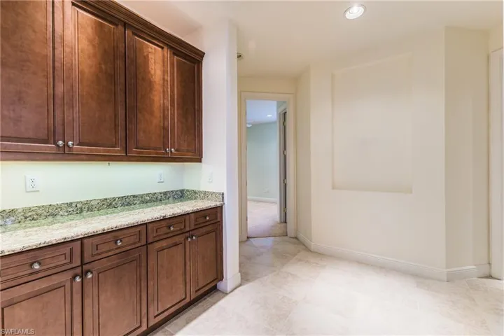 Kitchen featuring light stone countertops and recessed lighting