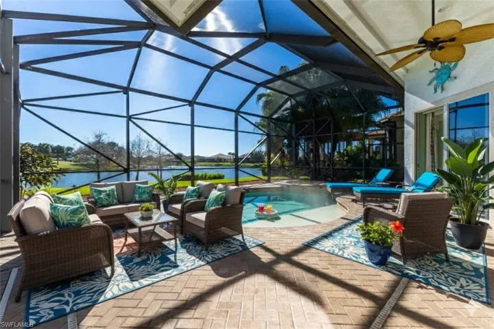 Staged Outdoor pool with an outdoor hangout area, a hot tub, a patio area, and glass enclosure