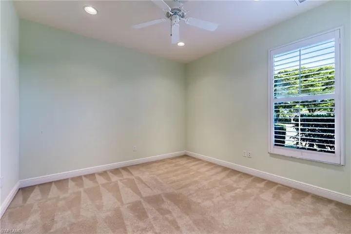 Spare room featuring recessed lighting, light colored carpet, and a ceiling fan