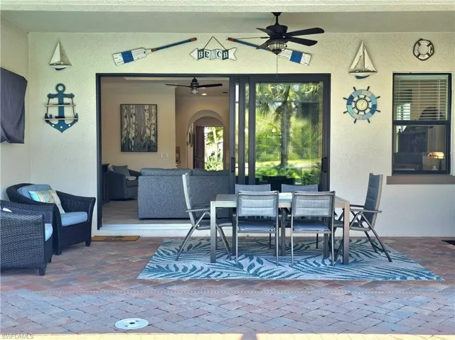 View of patio with a ceiling fan and outdoor dining space