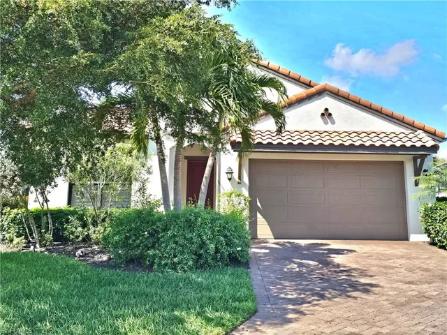 Mediterranean / spanish-style home featuring a garage, a tile roof, decorative driveway, and stucco siding