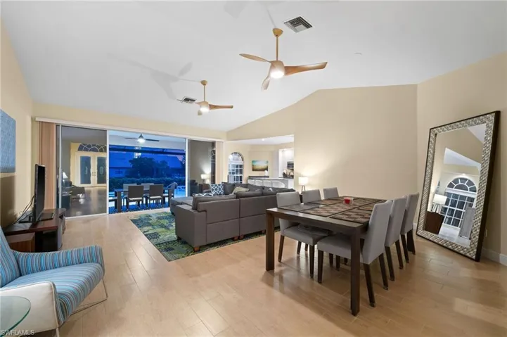 Dining space featuring lofted ceiling, ceiling fan, and hardwood / wood-style floors