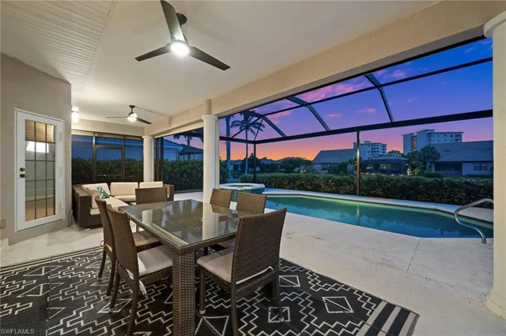 Sunroom / solarium with a swimming pool and ceiling fan