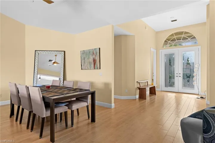 Dining room featuring plenty of natural light, french doors, light hardwood / wood-style flooring, and ceiling fan