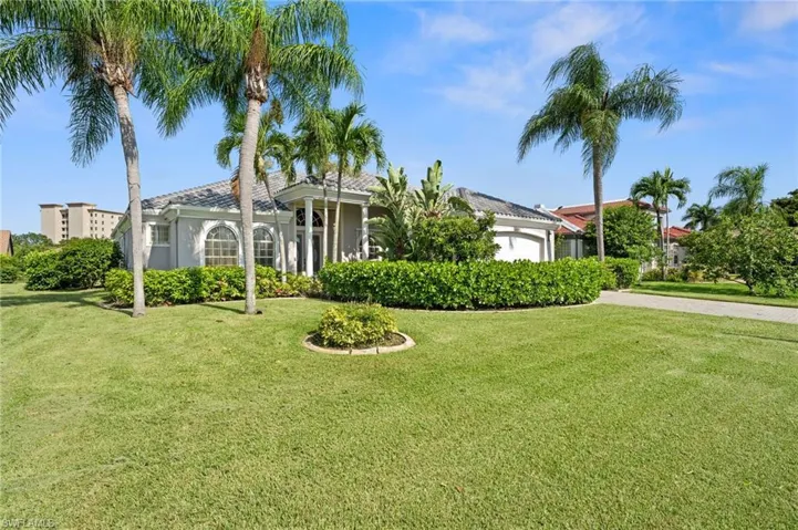 View of front facade featuring a garage and a front lawn