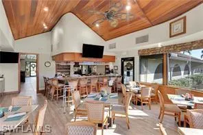 Dining room with a high wood ceiling, a ceiling fan, and wood finished floors