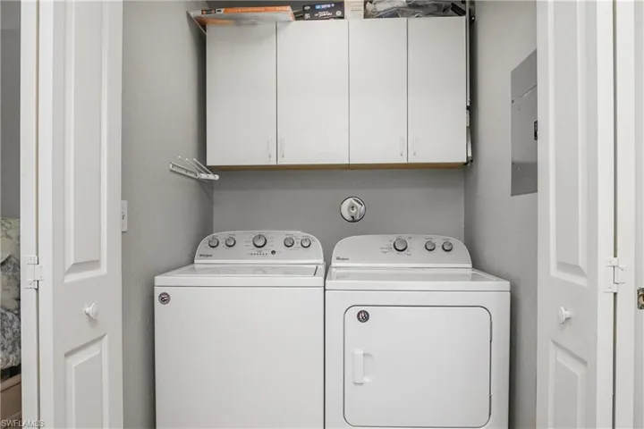 Laundry room featuring washing machine and clothes dryer and electric panel