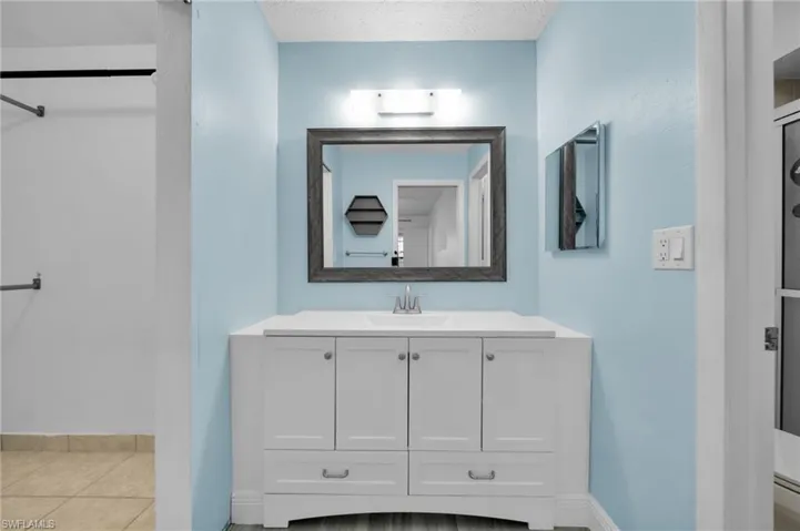 Bathroom featuring vanity, a textured ceiling, and tile patterned floors