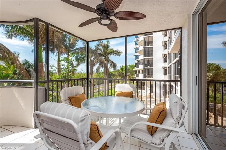 Sunroom / solarium featuring a balcony and a ceiling fan