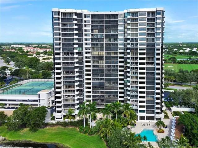 View of building / complex featuring a community pool and golf course view