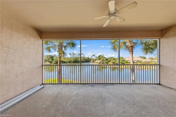Screened patio featuring a ceiling fan, textured walls, and concrete flooring