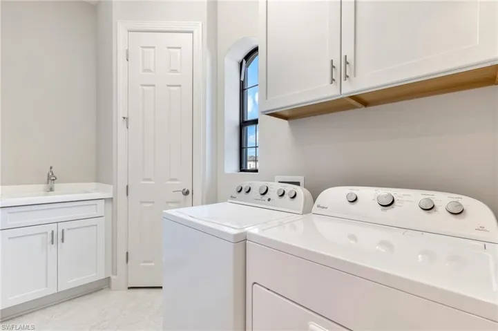 Laundry area featuring cabinet space and separate washer and dryer