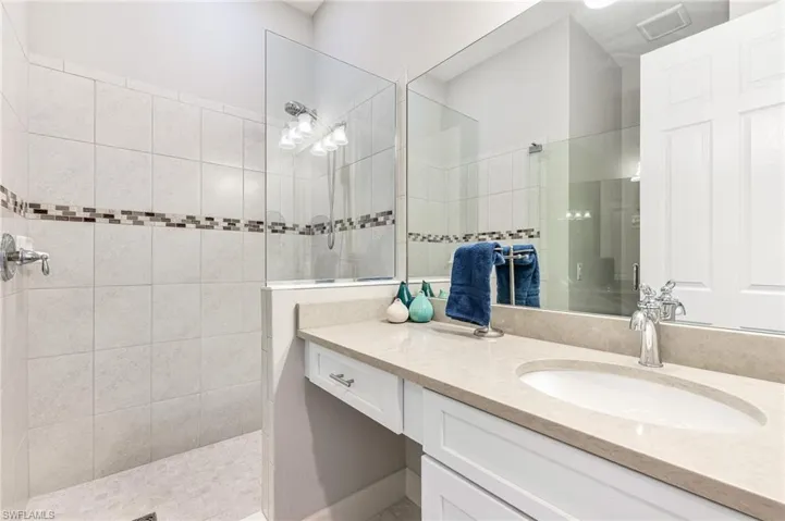Bathroom featuring vanity and a walk in shower