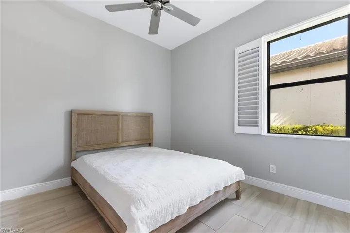 Bedroom with baseboards and ceiling fan