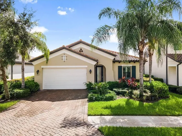 Mediterranean / spanish home featuring stucco siding, a garage, decorative driveway, and a tile roof