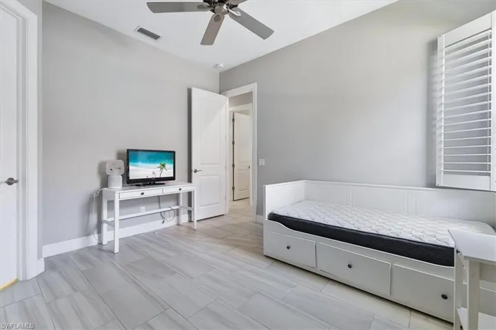 Living area featuring a ceiling fan and baseboards