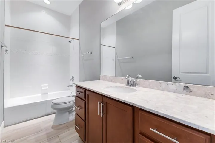 Full bath with vanity, toilet, and shower / bathtub combination