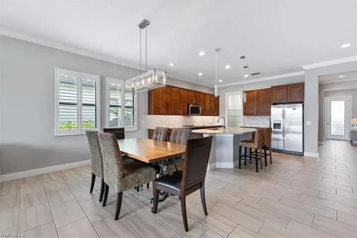 Dining area with recessed lighting, baseboards, and crown molding