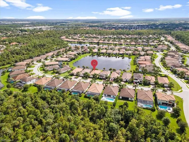 Aerial perspective of suburban area featuring a large body of water
