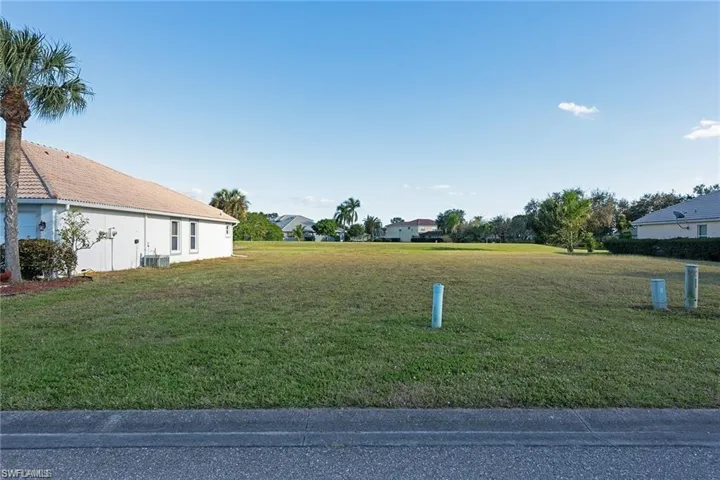 View of green lawn with a residential view