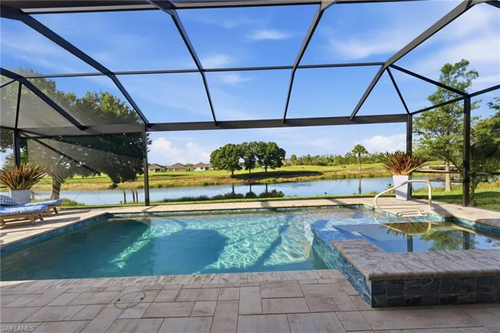 Pool/Spa with picture window view of the lake and golf course.