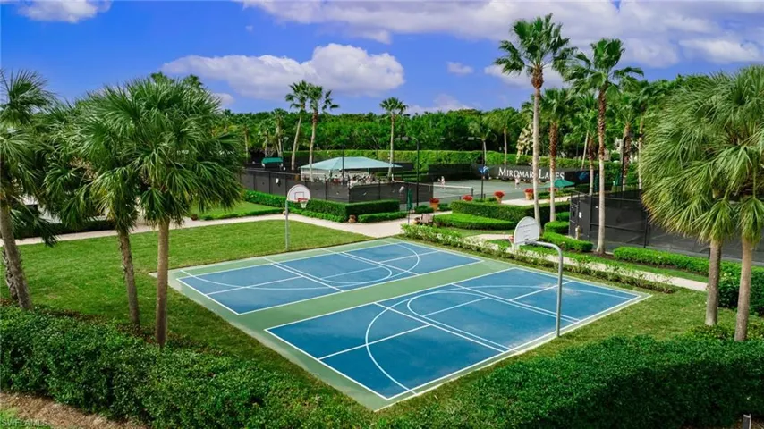View of sport court featuring a yard