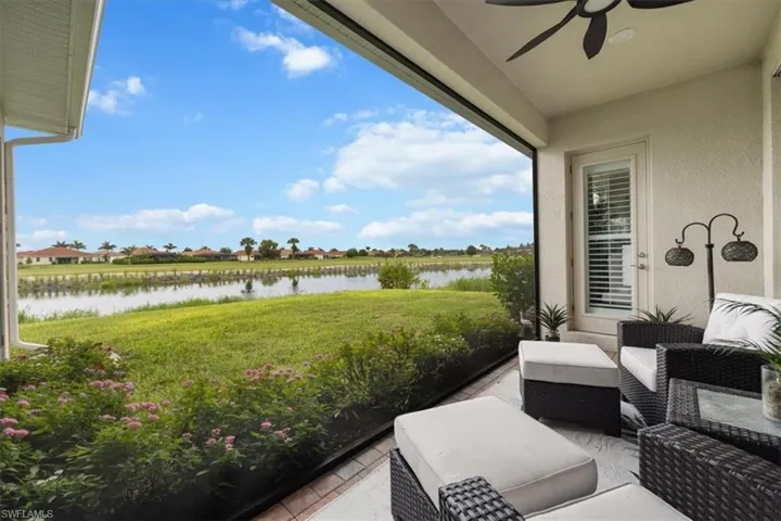 View of patio featuring a water view, a ceiling fan, and an outdoor living space