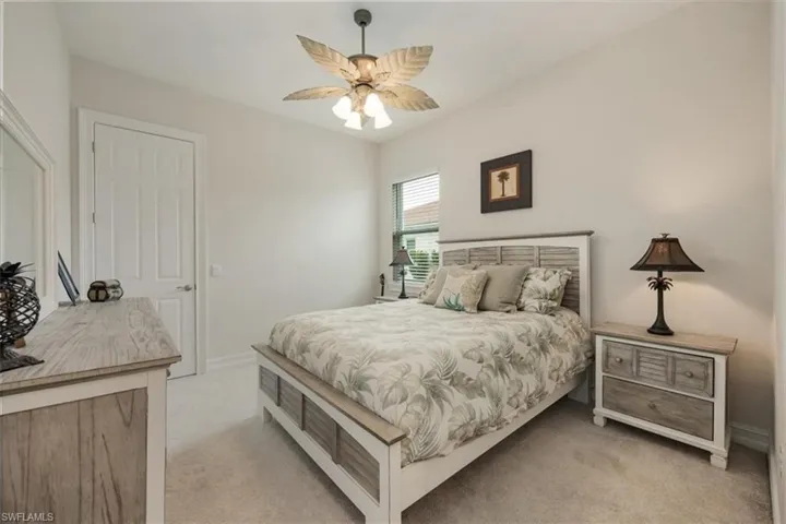 Bedroom with light carpet and ceiling fan
