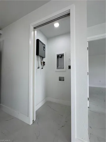 Hall with baseboards and light marble finish flooring