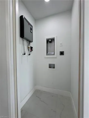 Laundry area with light marble finish flooring, washer hookup, and hookup for an electric dryer