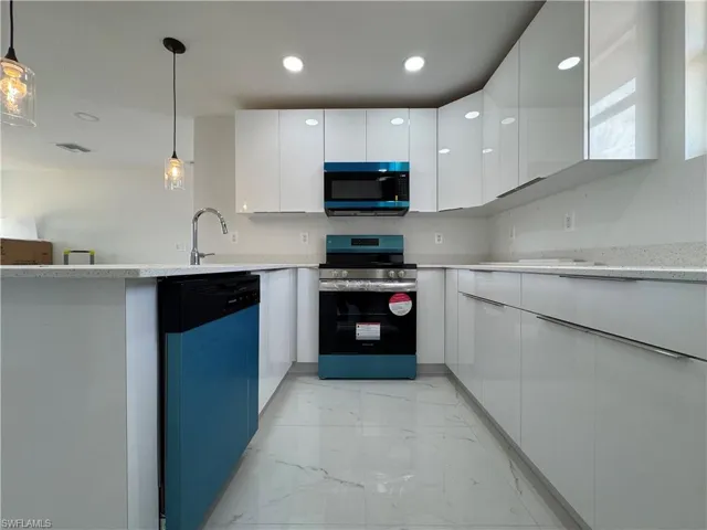 Kitchen with stainless steel electric range oven, white cabinetry, dishwashing machine, and modern cabinets