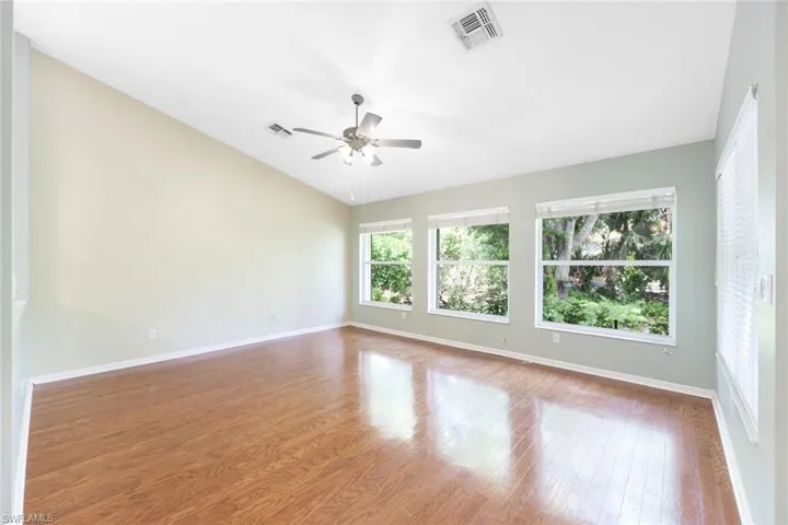 Spacious family room 17'1" x 14'4" with windows toward back yard. Hardwood flooring and vaulted ceiling.