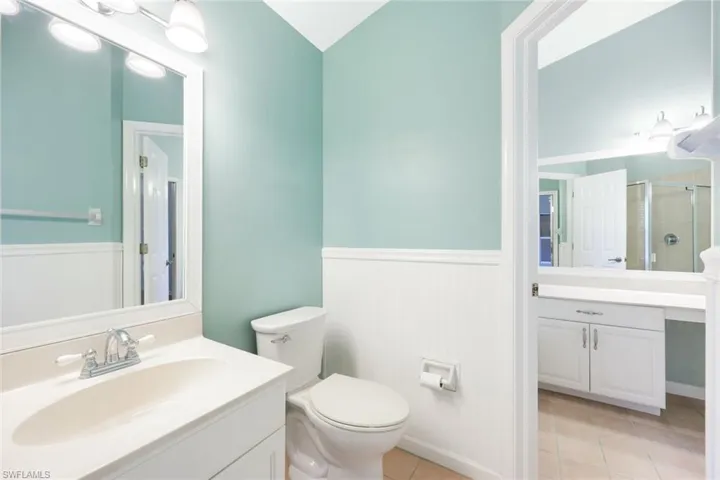 Another view of Master Bedroom bath with tile floors, vanity, and toilet