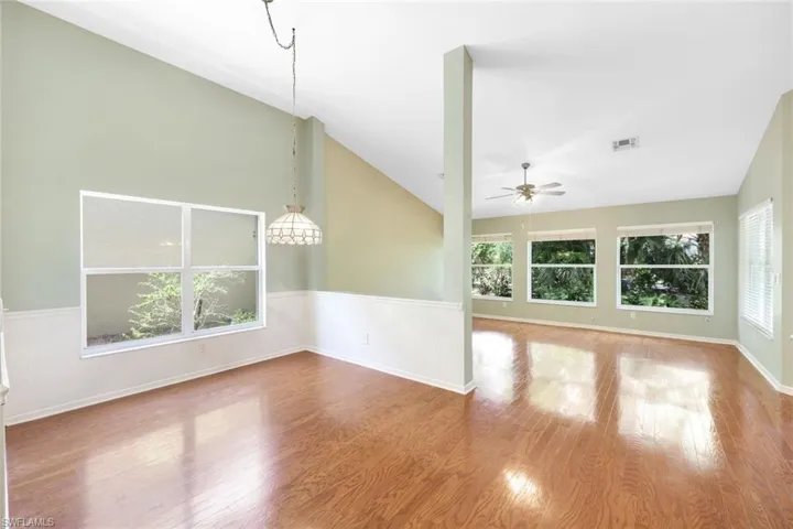 View of 12' x 10' dining area and family room toward back of home. Beautiful hardwood floors throughout.