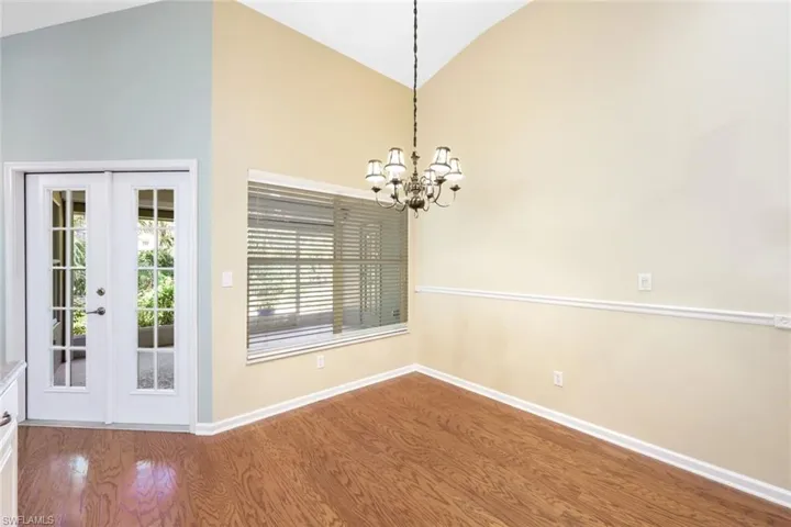 Breakfast eating area off kitchen, with high vaulted ceiling and french doors leading to lanai