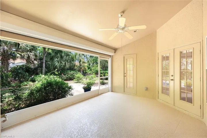 Lanai with electric storm shutter and private backyard view