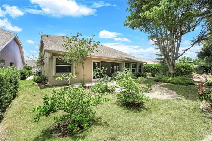 View shows back of home and landscaped area