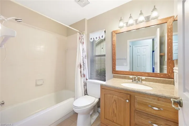 2nd Full Bath bathroom featuring tile flooring, toilet, vanity, with combo tub & shower