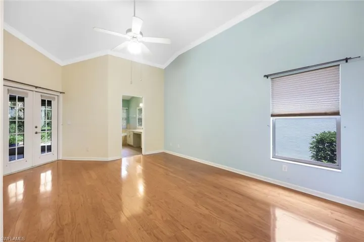 Master bedroom with vaulted ceiling, crown molding and french doors to lanai