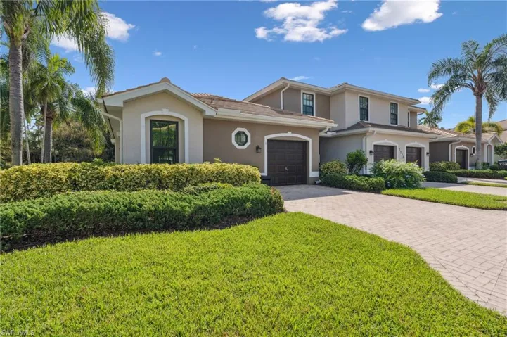 View of front of property with a front yard and a garage