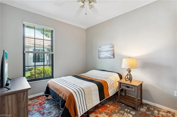 Bedroom featuring ornamental molding and ceiling fan