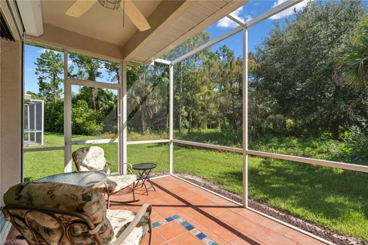 Unfurnished sunroom with ceiling fan