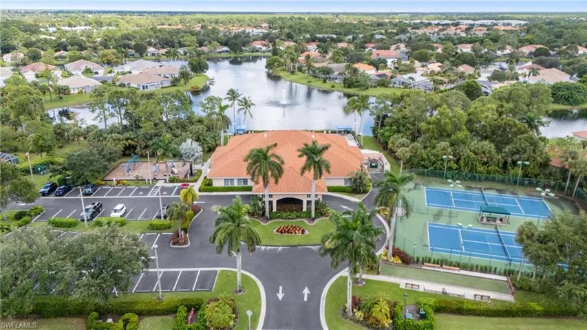 Birds eye view of property with a water view