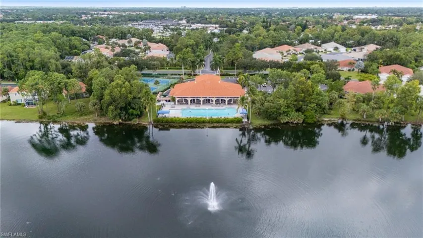 Birds eye view of property with a water view