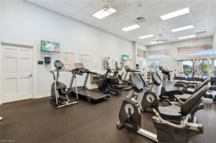 Workout area with a drop ceiling and a towering ceiling