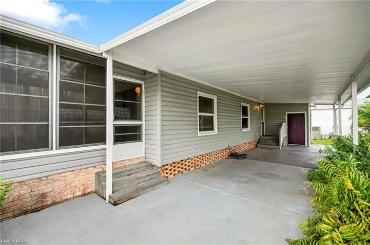 View of patio / terrace featuring entry steps and a carport